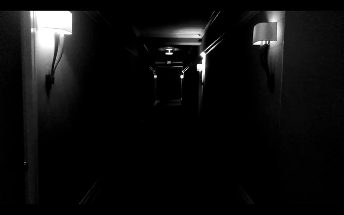 Black-and-white concept art of a shadowed hallway for The Tower.